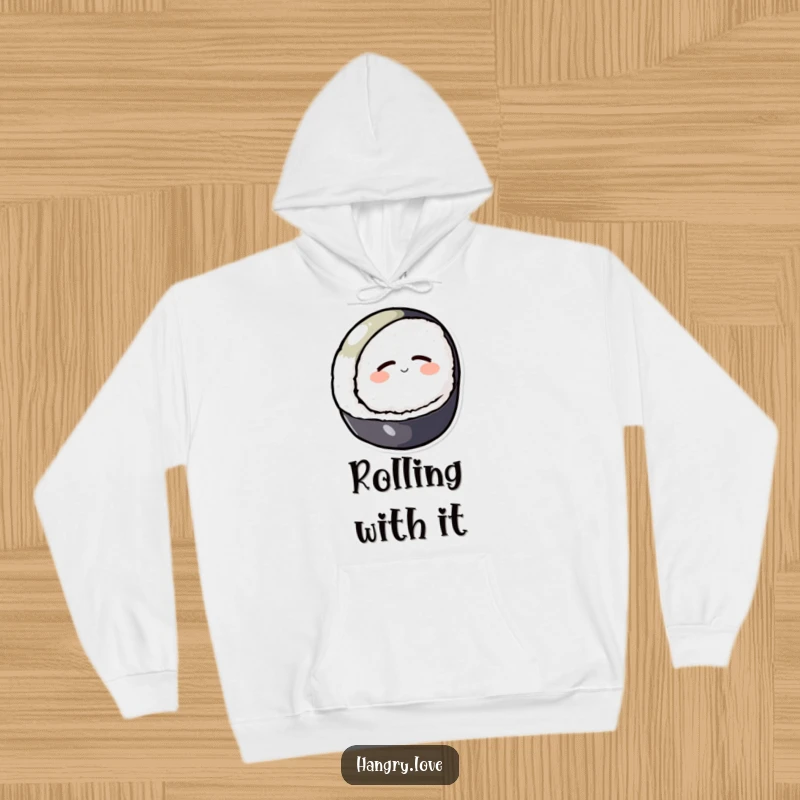 Funny hoodie featuring a round sushi character calmly rolling downhill with eyes closed, soft and warm.